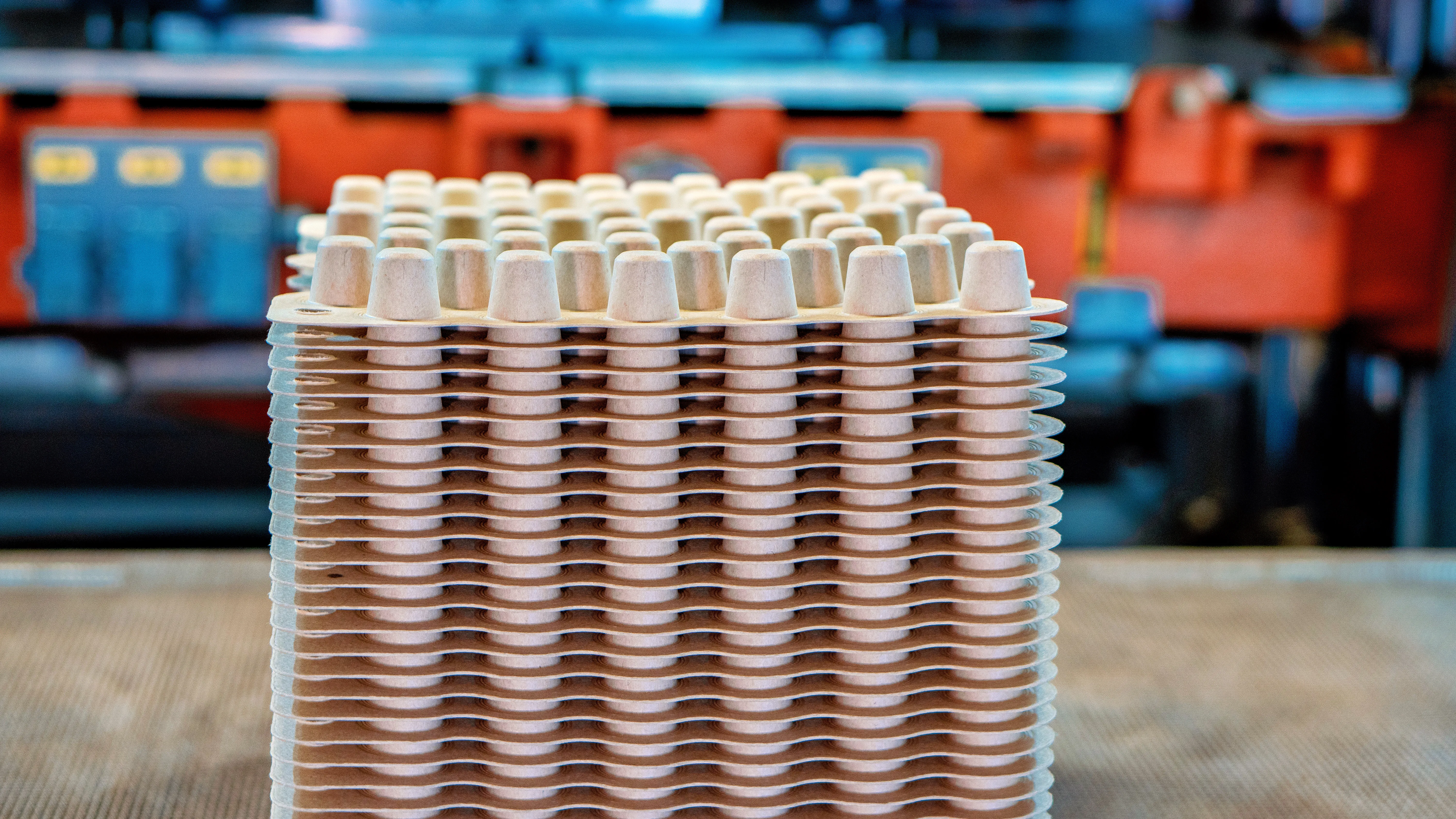 Stacked molded fiber coffee pods in production setting