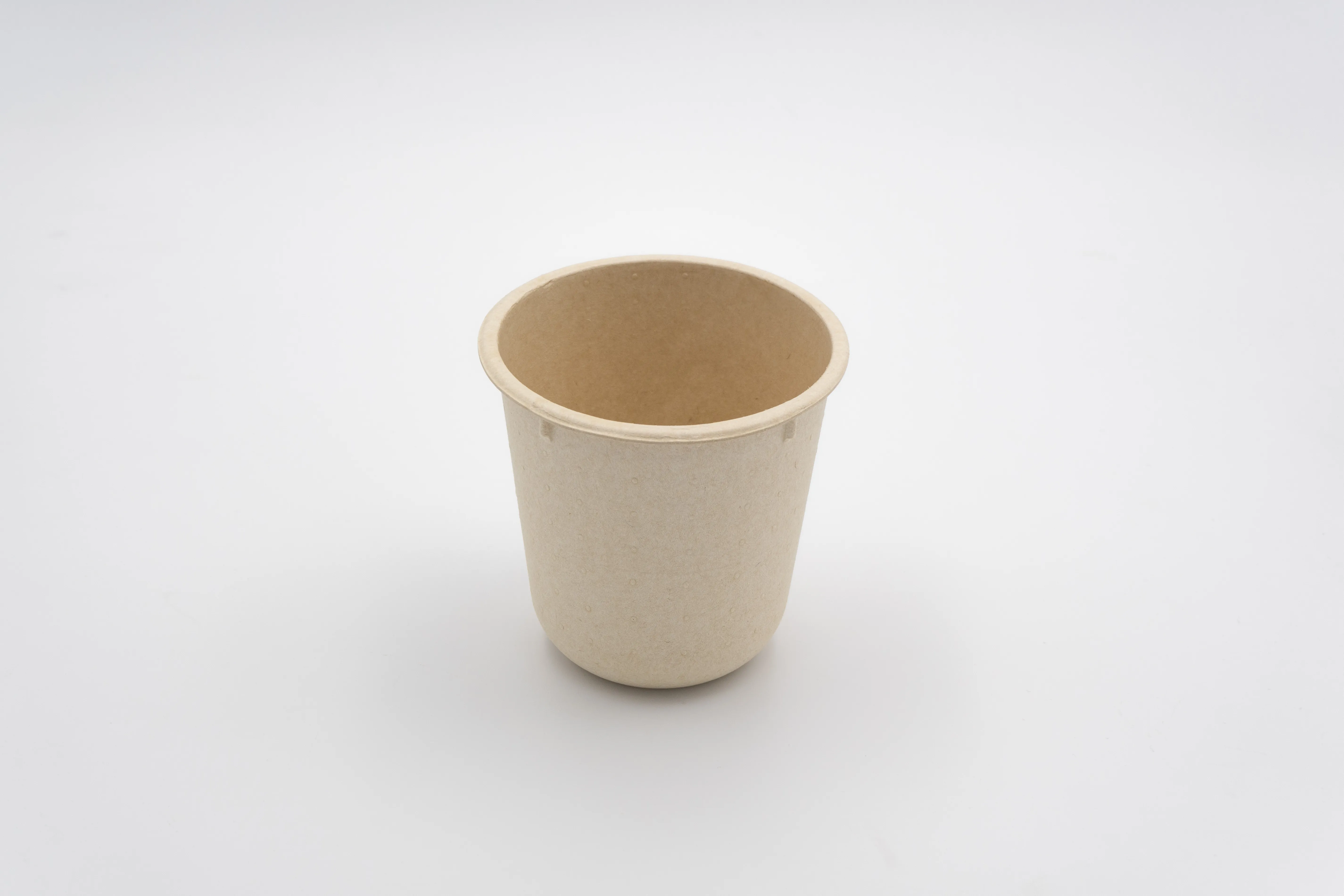 Neutral molded fiber yogurt cup sample on white background